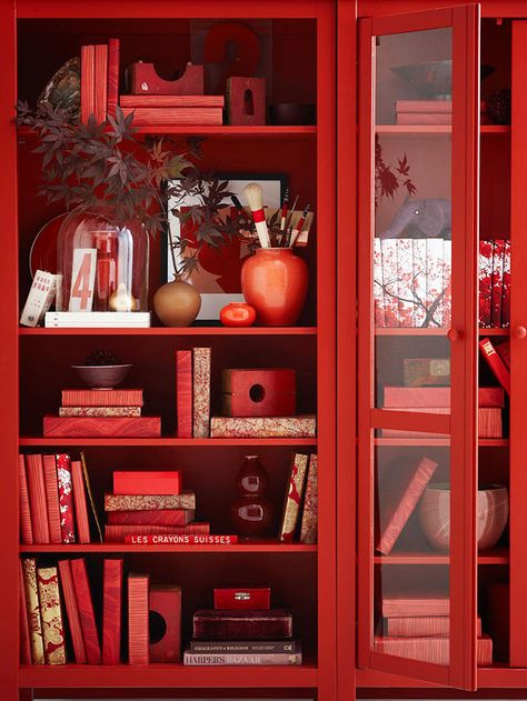 Bookcase Beauty.   Transform your everyday bookshelf into an autumnal display with a few simple tweaks. First, to create a consistent and graphic look, cover books with festive paper -- we love these tree- and floral-inspired prints. Then incorporate natural elements and accessories in fall hues. Red Bookcase, Monochromatic Interior, Feng Shui Elements, Simply Red, Red Rooms, Red Decor, Root Chakra, Red Aesthetic, Shades Of Red