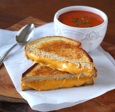 This tangy, easily prepared tomato soup is served with a golden, grilled sandwich containing three types of cheese. Grilled Cheese And Tomato Soup Aesthetic, Soup Images, Items Drawing, Quick Tomato Soup, Yummy Grilled Cheese, Tomato Soup With Grilled Cheese, Homemade Tomato Basil Soup, Homemade Macaroni Cheese, Soup And Grilled Cheese