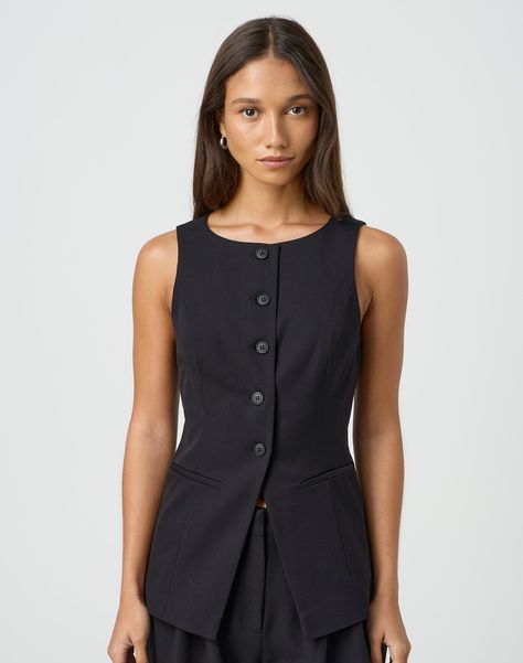 This tailored longline vest features a button through front, a rounded neckline and an adjustable back tie. Structured Vest Outfit, Corporate Vest Work Outfits, Black Work Wear Women, Button Front Vest Outfit, Corporate Lawyer Fashion, Tailored Vest Outfits For Women, Vest Women Outfit, Spring Work Outfits For Women, Summer Interview Outfit