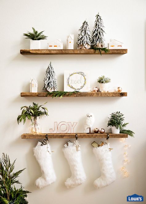 Floating shelves are great for everyday but they really shine during the holidays. Prominently display coordinated stockings, cards, greenery, and string lights for a cohesive look. Staircase Christmas Decorations, Staircase Christmas, Christmas Stairs Decorations, Rose Gold Christmas Decorations, Lights Ideas, Weihnachten Diy, Rose Gold Christmas, Simple Christmas Decor, Gold Christmas Decorations