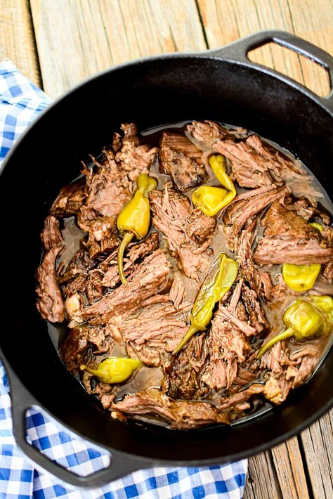 A chuck roast in a black dutch oven with peppers. Pot Roast Cast Iron Dutch Oven, Mississippi Pot Roast In Dutch Oven, Dutch Oven Mississippi Pot Roast, Mississippi Pot Roast Dutch Oven, Peppercini Roast, Chuck Roast Recipes Dutch Oven, Chuck Roast In Dutch Oven, Dutch Oven Chuck Roast, Oven Mississippi Pot Roast