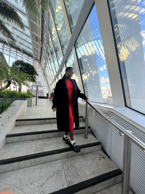 Girl wearying red cut out dress standing on the steps of the shy garden wearing long black coat with loafers and white socks. White Dress With Black, Long Black Coat, Dress Stand, Long White Dress, Cut Out Dress, White Socks, Out Dress, White Sock, Long Black