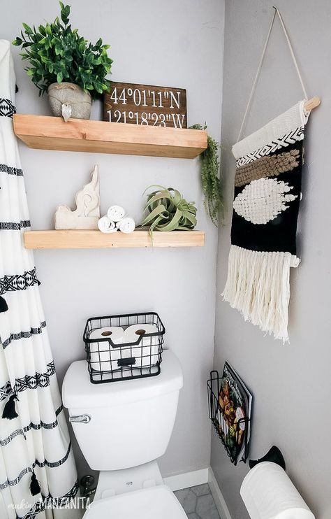 You're going to love this bathroom decor on these floating shelves over toilet that have a fun boho style, but still fit in with the modern farmhouse theme! Perfect for some extra storage for towels and other things in a small bathroom. I love the wire basket on the back of the toilet to hold toilet paper. #boho #bathrooms #smallbathroom #bohostyle #bathroom Floating Shelves Over Toilet, Makeover Kamar Mandi, Bathroom Mosaic, Shelves Over Toilet, Ideas Baños, Themes Ideas, Over Toilet, Farmhouse Shelves, Bathroom Themes