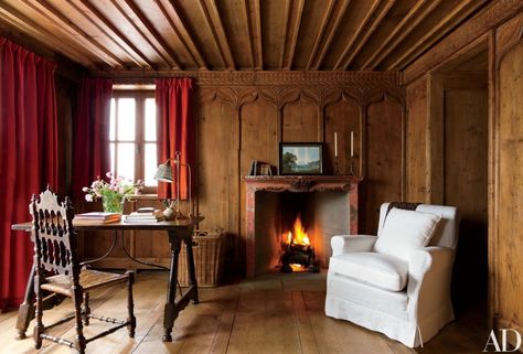 In the second master bedroom, a 19th-century painted mantel offsets the honey-tone paneling | archdigest.com Painted Mantel, Studio Peregalli, Spanish Chair, Chalet Chic, Chalet Interior, Swiss Chalet, Rustic Background, Attic Renovation, Attic Remodel