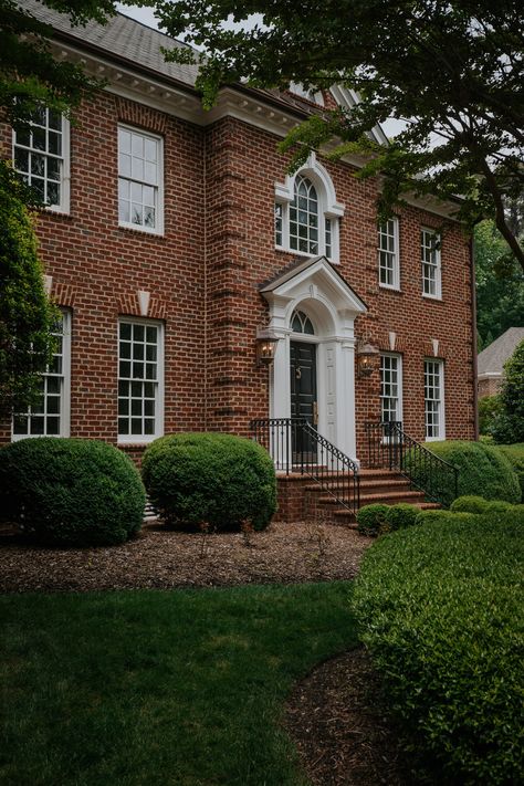 Meet our Colonial home in North Carolina! - Chris Loves Julia Modern Colonial Exterior Brick, Brick Georgian House Exterior, Classic Brick House Exterior, Red Brick Colonial House, English Brick House, Shutters Or No Shutters, Red Brick Colonial House Exterior, Red Brick House Landscaping, Georgian Colonial House Exterior