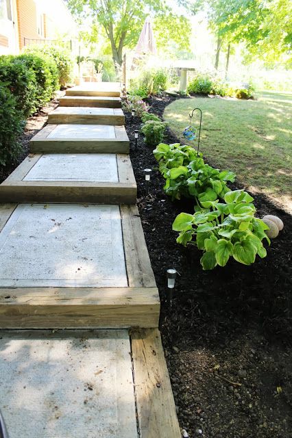 Blogger Elizabeth of Ohio Thoughts needed a walkway in between her back door and garage. She made this one using salvaged wood beams and concrete. Check out more of our favorite DIY garden paths. Reka Bentuk Landskap, Taman Diy, Cheap Landscaping Ideas, Backyard Walkway, Concrete Patios, Jardim Diy, Pathway Landscaping, Garden Stairs, Garden Stepping Stones