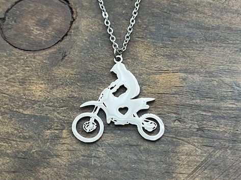 "Dirt Bike Necklace, Motorcycle Necklace, Gift for Biker, Biker Gift, Dirt Bike Rider Gift, Dirtbike Jewelry, Gift for Her or Him Stainless steel pendant and chain. Pendant is 1\" Please note each item is personally engraved/hand stamped by me and no two pieces will be alike. Text and design may not be perfectly straight which gives you the unique detail of your charm. This should not be considered a defect in craftsmanship. *Please check shop announcements for shipping details. If you have any Gifts For Dirt Bike Lovers, Motorcycle Necklace, Bike Necklace, Man Gold Bracelet Design, Gift For Biker, Dirt Bike Birthday, Bike Sketch, Cute Clothing Stores, Biker Love