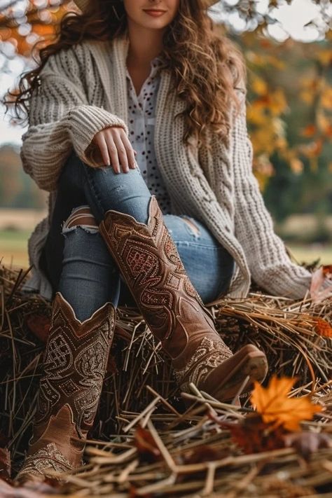 https://www.fromtheguestroom.com/wp-content/uploads/2024/08/A-woman-wears-ripped-jeans-brown-cowboy-boots-and-cardigan.webp 2024 Fall Boots Outfits, Cowgirl Modest Outfits, Christmas Outfit With Cowboy Boots, Maroon Cowboy Boots Outfit, Cowgirl Style Outfits Fall, How To Wear Western Boots, Western Fall Outfits Women, Chestnut Boots Outfit, Fall Outfits Cowboy Boots