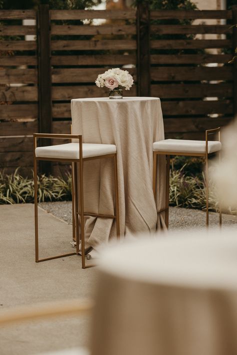 This image is during a wedding cocktail hour. Featuring a cocktail table with blush and white florals in a 4x4 glass cylinder vessel. The linens on the cocktail tables are a champagne metallic twist. High Top Cocktail Tables, Cocktail Wedding Table Decor, Wedding Cocktail Table Decor, Cocktail Hour Tables, Wedding Cocktail Tables, Cocktail Table Decor, Top Table Flowers, White Cocktail Tables, Wedding Cocktail Hour