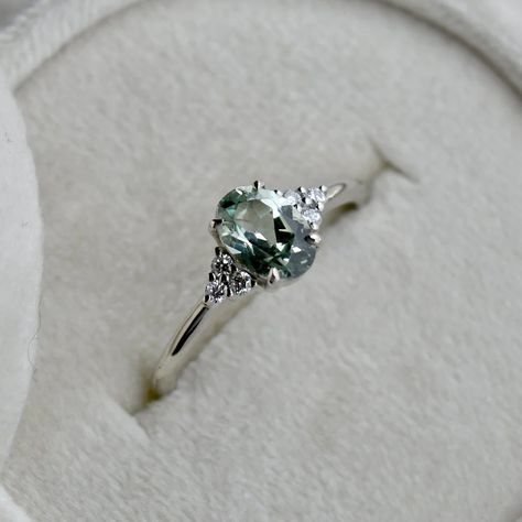 14k White Gold Aria Oval Green Sapphire Engagement Ring | Magpie Jewellery Simple Silver Diamond Ring, Simple Green Engagement Rings, Sage Green Engagement Ring, Light Green Engagement Ring, Simple Silver Engagement Rings, Green Engagement Rings, Pretty Engagement Rings, Silver Promise Rings, Green Sapphire Engagement