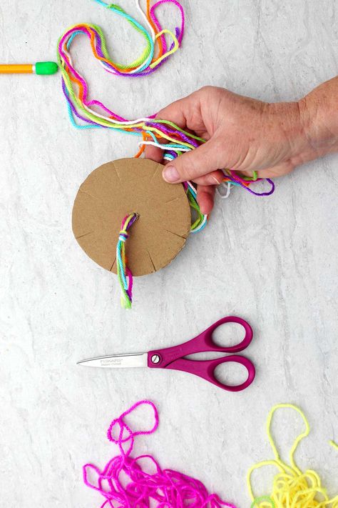 Make a DIY Round Friendship Bracelet with a Cardboard Loom. So easy and the braided round bracelet looks awesome! A great friendship gift! #WelcometoNanas #FriendshipBracelet #CardboardLoomCraft #MakeAFriendshipBracelet Bracelet Cardboard Circle, Friendship Bracelet Cardboard Circle, Cardboard Loom Bracelet, Wwjd Bracelet Diy, Cardboard Bracelet Maker, Friendship Bracelet Tutorial Easy, Easy Friendship Bracelets, Diy Friendship Bracelets Easy, Cardboard Loom