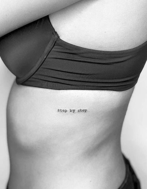 Writing On Ribs Tattoo Women, Tattoo Ideas On Ribs Quote, Stepping Into A New Me Tattoo, Text Tattoo Side Rib Women, Small Tattoos On Rib Cage, One Line Rib Tattoo, One Word Rib Tattoo, Dainty Rib Cage Tattoos, Minimalist Tattoo Side Rib