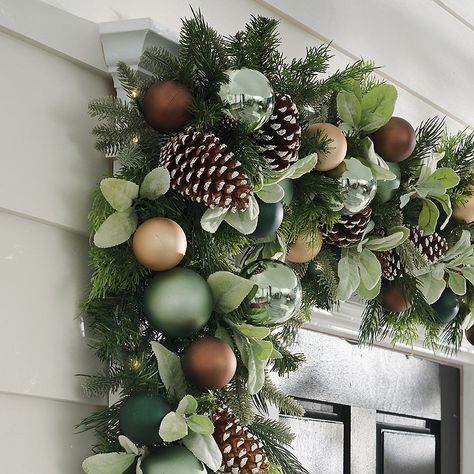 Pre-lit holiday garland featuring ornaments and lifelike greenery . Shatterproof ornaments in a variety of finishes and sizes on a bed of lifelike, mixed evergreen and lamb's ear, soft to the touch . Glows with 60 warm white LEDs . Convenient, optional 6-hour timer; set once for the season to light same time each night for 6 hours, off for 18 hours . Three-way switch: on/off/automatic 6-hour timer . Battery-operated convenience means no cords to conceal or plugs to locate . Powered by three C ba Yule Inspiration, Grandin Road Christmas, Door Garland, Christmas Party Decor, Copper Christmas, Green Xmas, Holiday Garland, Lamb's Ear, Christmas Garlands