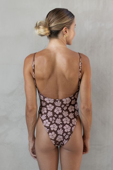 Get ready to make a tropical statement with the LOKAHI Eva One Piece in Brown Tropics! This stylish swimsuit features a flattering silhouette and vibrant brown tropics pattern. Perfect for a day in the sun, this one piece offers both style and comfort. Make a splash and stand out from the crowd!