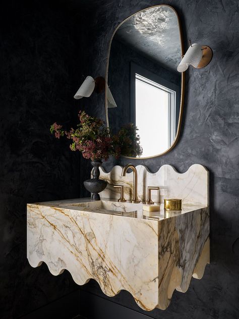 The seemingly melted marble sink, gold accents, and dark lime washed walls create a dramatic, luxurious statement in this bold powder room. Powder Room Sink, Marble Sinks, Marble Vanity, Powder Bath, Amber Interiors, Plaster Walls, Interior Inspo, Bathroom Inspiration, Powder Room