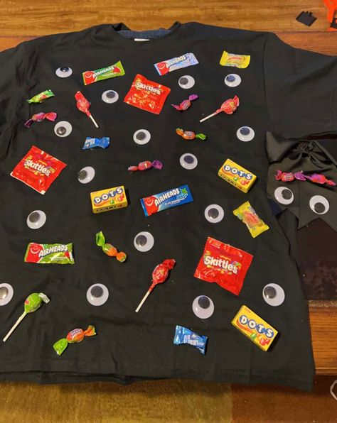 An easy DIY halloween costume is Eye Candy just hot glue google eyes and canys on a shirt (I also made a bow to go with it). Make sure you pur something inside thw sirt before you hot glue or it will stick to the other aide of the shirt. Total to make this was about $15 thats including the bow but it could be made for less. Easy Candy Costumes Diy, Candy Wrapper Costume, Eye Candy Costume, Candy Shirt Ideas, Simple Diy Costumes Women, Candy Halloween Costume Diy, Candy Costume Ideas, Candy Costume Diy, Candy Costumes Diy