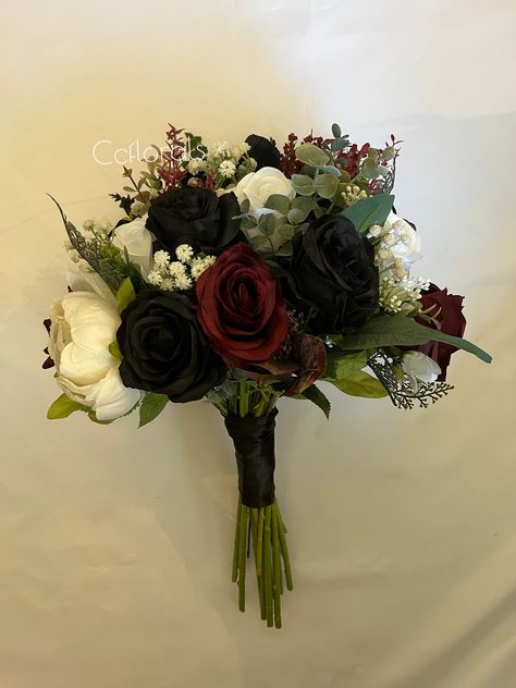 ,CcfloralsWedding bouquet,Burgundy black white flowers Fall bridal bouquet  green Bridesmaid bouquet Halloween wedding bouquet, Boho bouquet  bride bouquet measures 12-14" in width and height  bridesmaids bouquet measures 8-10" in width and height  featured colors are : black, burgundy white  mix of high quality artificial flowers, roses and eucalyptus  *custom orders are always welcomed send us a message  Capture the essence of fall with our Autumn  Artificial Wedding Flowers. Featuring a stunning blend of vibrant autumn hues, these meticulously crafted flowers bring the warmth and beauty of the season to your special day. Perfect for bouquets, centerpieces, and decor, they offer timeless elegance without the worry of wilting. Make your wedding unforgettable with the vibrant colors and ev Black White Red Bouquet, Red Black Gold Bouquet, Halloween Wedding Bouquet Ideas, Red Black And White Wedding Bouquets, Black Rose Wedding Bouquet, Black And Red Flower Bouquets, Red White And Black Wedding Theme, Red And Black Bouquets, Black And Burgundy Wedding Decorations