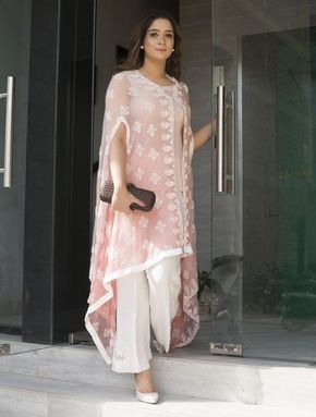 This summer season try the trendy Cape Kurtis. Know the various Cape Style Kurti Designs and patterns that are perfect for any casual occasion. White Pants, Cape, A Woman, Glass, Pants, Pink, White, Trousers