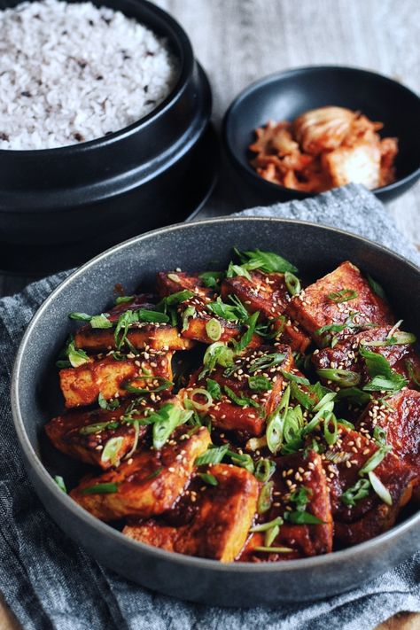 Korean Spicy Braised Tofu, also known as Dubu Jorim, is easy, quick, and absolutely delicious. Thick slices of tofu are braised in a mouthwatering sauce that's equal parts savory, spicy, and full of umami flavor. A 15-minute recipe that's full of good-for-you, plant-based protein that's simmered in sauce until tender. Satisfying, simple, and tasty -- it's a Korean home cooking staple for a reason! Dubu Jorim Recipe, Korean Banchan Recipes, Dubu Jorim, Korean Sides, Korean Feast, Korean Soy Sauce, Korean Banchan, Braised Tofu, Tofu Sauce