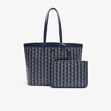 This canvas tote features the iconic Lacoste monogram, for a bold, elegant look. The two large handles mean it can be carried over the shoulder or by hand. Large enough to hold a 17" laptop, it also features a small patch pocket and a removable zipped pouch.