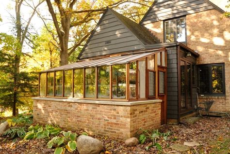 An 8x14 Garden Sun Room set on a brick base wall.  The base wall matches the house.  Jalousie windows are added for ventilation. Greenhouse Attached To House, Greenhouse Addition, Garden Sunroom, Sunroom Greenhouse, Lean To Conservatory, Solar Greenhouse, Conservatory Greenhouse, Heating A Greenhouse, Cold Frames