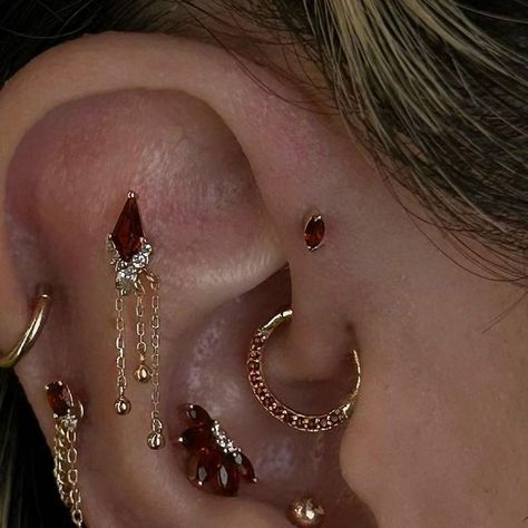 Nathans Tattoos and Piercings on Instagram: "Stunning curation by @sashapokey using @buddhajewelryofficial garnet pieces✨  #buddhaearstyle #earcuration #curation #buddhajewelry #buddhajewelryofficial #ultimateear #ultimatecuration #epicearcuration #piercedbtnathan #upgradedbynathan #nathans #nathanstattoosandpiercings  #losangelestattoo #losangelespiercing #losangelespiercer" Ears With A Lot Of Piercings, Blue Piercings Ear, Goth Piercings Ear, Black And Gold Ear Piercings, Ear Style Ideas, Stacked Jewelry Earrings, Eat Curation Ideas, Eat Curation, Piercings With Gauges