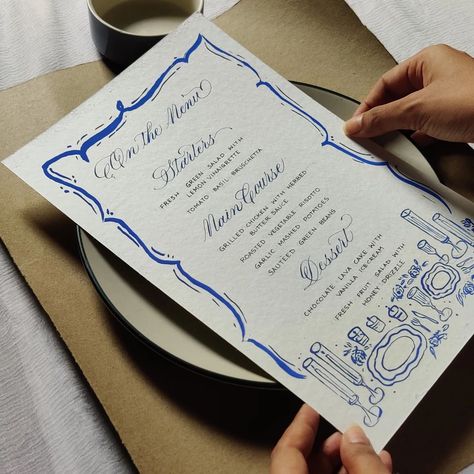 💠 Hand Written & Hand-painted menu design 💠 Classic | Simple | Vibrant Sharing more on this later today. ☁️✨😬💙 #handwritteninvites #handwrittenmenu #handwrittenmenus #blueink #cerulean #ceruleanblue #customink #handmade #sitdowndinner #tablesetup #calligraphymenu #illustratedmenu #menucards #menudesigns #menucarddesign #gouachpaints #illustration (Customized, menu cards, calligraphy, artist, Kolkata, hand drawn, illustration, gouache, dinner menu) Vegetable Risotto, Menu Card Design, Sauteed Green Beans, Calligraphy Artist, Garlic Green Beans, Chocolate Lava, Chocolate Lava Cake, Garlic Mashed Potatoes, Lemon Vinaigrette