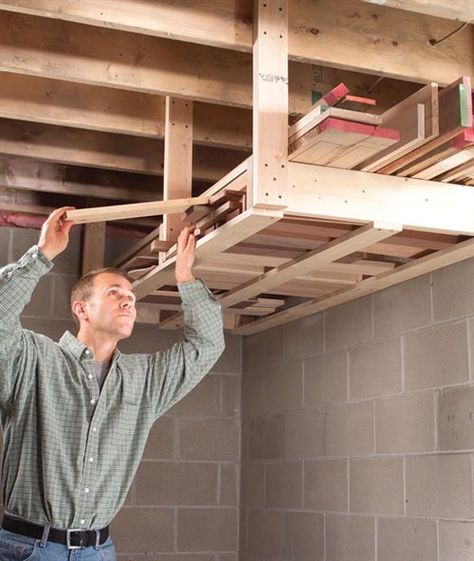 I like working in my basement shop, but the floor space is limited. So when it came time to put up a lumber rack, I screwed it to the ceiling because that’s the only space that was wide open. I designed the rack so it holds both long and short boards and installed it at a height that is convenient to reach but high enough so I … Shed Organisation, Basement Shop, Officine In Garage, Lumber Storage Rack, Lumber Rack, Garage Atelier, Lumber Storage, Shed Organization, Garage Organize