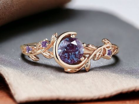 Nature Inspired Color-Change Alexandrite Engagement Ring 14K Gold Moon Star Design Round Alexandrite Amethyst Ring Branch Leaf Wedding Ring ITEM SPECIFICATIONS: Main Stone - Alexandrite Stone Creation - Lab Created Stone Shape - Round Stone Color - Purple Stone Size - 6 MM Secondary Stone - Amethyst (Lab Created) Stone Shape - Round Stone Color - Purple Metal: Silver Method: Cast Personalization: Possible Style: Wedding Ring Set Ring Size: We make rings from US 3 to US 18. This elegant ring is p Artistic Rings Unique, Fantasy Inspired Rings, Purple And Gold Ring, Amethyst Engagement Ring Silver, Engagement Rings Amethyst, Engagement Rings Purple, Purple Wedding Ring, Purple Wedding Rings, Fantasy Rings