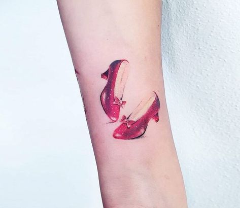 Dorothy Shoes tattoo by Ilaria Tattoo Art Dorothy Red Shoes, Shoes Tattoo, Oz Tattoo, Dorothy Shoes, Feminist Tattoo, Shoe Tattoos, Cool Wrist Tattoos, Mommy Tattoos, Last Unicorn