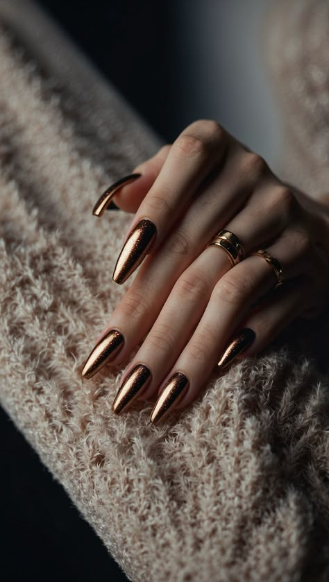 Close-up of a hand with long metallic bronze nails and rings on fingers French Tip Velvet Nails, Bronze Christmas Nails, Gold Bronze Nails, Bronze Metallic Nails, Cooper Chrome Nails, Romantic Nails Designs, Bronze Nails Designs, Copper Nails Designs, Hollywood Prom