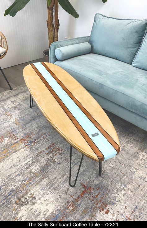 The "Sally" is a surfboard coffee table is the best of all worlds, it lets the natural wood shine, has a bit of stain and features a beautiful pale turquoise stripe from end to end with a white stringer. The finishing touch is 4 perfectly placed black pin stripes. The epoxy finish provides durability and depth to the natural wood.  Please note the grain pattern for each board will be different, but we will do our best to make is look as close to Beach Wood Furniture, Surfer Style Living Room, Beachy Boho Furniture, Surfboard Coffee Table Diy, Decorating Beach House Ideas, Beach Theme Salon, Hawaii Apartment Decor, Blue Ocean Bedroom Aesthetic, Vintage Surf Shop Aesthetic