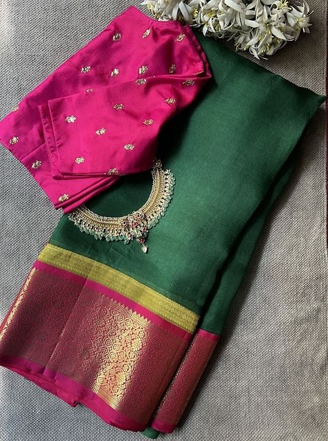 Mishrita dark green organza silk saree -  Mishrita sarees are a signature fusion range from the house of Aavaranaa. As a means of upcycling and sustainability , we have made these unique saree a sense of pride for ourselves. The saree has a pure organza silk body with pure zari kanchi silk borders and pallus. The saree also comes with a contrast blouse piece like the pallu colour. Saree being light and easy to drape is a great and funky alternative to the otherwise traditional kanchipurams itself. To view our mishrita sarees, pls click on https://aavaranaa.com/product-tag/mishrita/ Dark Colour Dresses, Dark Green Saree Contrast Blouse, Dark Green Saree, Unique Saree, Pearl Blouse, Saree Styling, Blouse Designs High Neck, Organza Silk Saree, Indian Saree Blouse