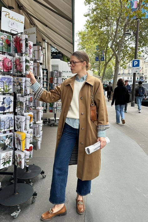 @elodieromy is wearing the Sézane Clyde Trench, paired with Vicky loafers, the Max striped shirt, and a cozy white knit sweater. This effortlessly chic outfit is perfect for transitional fall weather. Shop this outfit online now at sezane.com. Striped Shirt Outfit Fall, London Outfit Ideas, Outfits With Striped Shirts, Simple Wardrobe, Fall Layering, London Outfit, Effortlessly Chic Outfits, White Knit Sweater, Chic Outfit