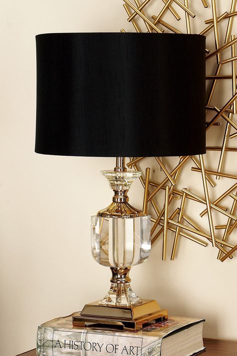 Impress visitors with this refined lighting decor. Gold colored iron accents stand out against the lamp   s clear crystal body. The lamp   s black drum shade adds dimension to the space and features a gold interior. A 6" base makes it easy to place the decorative lamp on an end table or desk. The fixture is a gorgeous complement to a glam style living room or bedroom. Uses one standard E26 light bulb (not included). Cord length measures 62". Suitable for indoor use only. Desk light has an easy o Salt Lamp Decor, Glam Style Living Room, Hollywood Glam Decor, Glam Lamps, Glam Table Lamps, Black And Gold Living Room, Glam Table, Gold Bedroom Decor, Glamour Decor