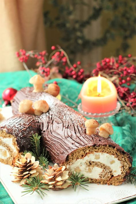 German Yule Log on a white platter with marzipan pinecones in front and marzipan mushrooms on top, candle and red berries behind Vertical Cakes, How To Make Marzipan, Yule Log Recipe, Sponge Cake Roll, Christmas Yule Log, Christmas In Germany, Cake Rolls, White Platter, Gluten Free Christmas