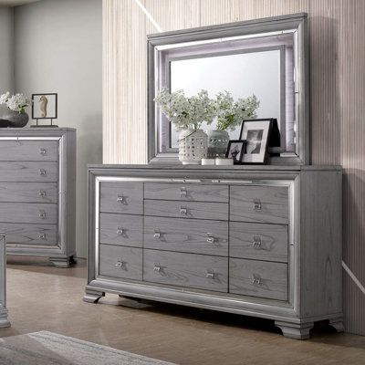 This beautifully finished light gray chest offers 8 regular drawers and 2 jewelry drawers that run on ball bearing metal glides with sturdy English dovetail construction. The mirror trim borders the drawers and complements the natural wood grain pattern perfectly. This piece rests on wooden brack feet for extra stability and balance. | Everly Quinn Orrwell 10 Drawer Double Dresser w / Mirror Wood in Brown / Gray, Size 41.0 H x 66.0 W x 17.5 D in | Wayfair Light Gray Bedroom, Transitional Dresser, Drawers Design, Grey Dresser, Mirror Trim, Oak Dresser, Wood Grain Pattern, 9 Drawer Dresser, Bedroom Panel