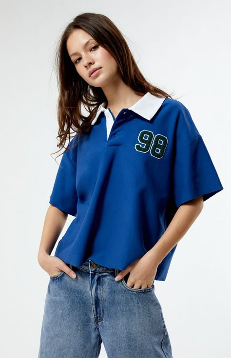 PacSun's Oversized Rugby T-Shirt brings a touch of preppy charm to the scene. Featuring a classic collared neckline, button closures, short sleeves, left chest patches, and the perfect relaxed fit, it's the epitome of laid-back style. Score some easygoing vibes with this must-have tee.   	Collared neckline 	Short sleeves 	Button closures 	Relaxed oversized fit 	Left chest patch detail 	Machine washable 	Model is wearing size small 	Model measurements: 5’7” height, 32.5” bust, 25.5” waist, 36” hip Pacsun T Shirts, Rugby Shirt Aesthetic, Short Sleeve Button Up Shirt Outfit, Oversized Polo Shirt Outfit Women's, Oversized Polo Outfit, Blue Tshirt Outfit, Nba Style, Plain Clothes, Oversize Tshirt Outfits