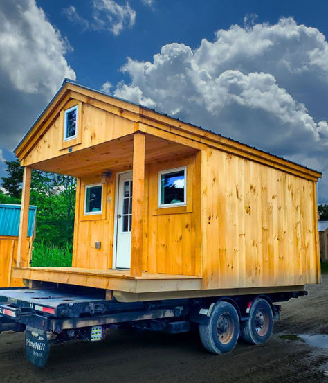 A tiny house with a loft extending over the porch on a trailer. Bunkie Plans With Loft, Hunting Shack Interior, Tiny Lake Cabin, Bunk House Ideas, Bunk House Shed, Bunkhouse Ideas Guest Cabin, Hunting Cottage, Small Hunting Cabin, Built In Bunk Beds