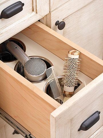 Customize Cabinets:  Here a deep drawer can safely hold a hot flat iron and other primping tools after use. Custom-fit stainless-steel canisters allow these beauty tools to cool safely inside the drawer as well as house brushes, combs, and a hair dryer. Need to do this in my daughters bathrooms! Curling Iron Storage, Diy Bathroom Storage Ideas, Diy Bathroom Design, Bathroom Drawers, Diy Bathroom Storage, Vanity Drawers, Creative Storage Solutions, Vinyl Decor, غرفة ملابس