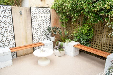 The best way to cover up unsightly walls and fences is with large-scale outdoor screens, says Dan. “We chose these decorative breeze brick-look screens which instantly created Palm Springs vibes in this tired courtyard.”  “If you have a larger space to work with, you could also anchor the screens at the base with besser blocks and use them to separate the outdoor area and create different zones for reading, dining and more,” says Dan. Besser Block, Outdoor Hacks, Cinder Block Walls, Easy Diy Hacks, Outdoor Screens, Small Courtyards, Diy Fence, Rental Decorating, The Courtyard