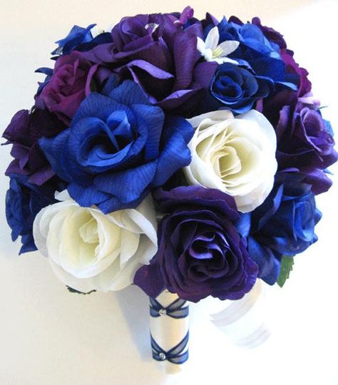 IF YOU NEED DIFFERENT QUANTITIES, DIFFERENT COLORS OR MATCHING DECORATION ITEMS PLEASE CONTACT US FOR A CUSTOM PRICE QUOTE.  This listing is for a 17-piece package including the following items: 1 Bride's Round bouquet (10" round) made with Purple, Plum and Royal Blue Roses, few Light purple and Cream roses, few Light purple Stephanotis and Ivory accent flowers decorated with Sparkling Diamonds. The thick handle is wrapped in Ivory Satin and decorated with Dark blue French braided design, Diamond pins and Ivory organza bows  1 maid of Honor Round bouquet (8" round) made with same flowers as the bride's bouquet. The thick handle is wrapped in Ivory Satin and decorated Ivory organza bows  4 Bridesmaids Round bouquets (7" round) made with same flowers as the bride's bouquet. The thick handle Blue Purple Wedding, Bridal Wedding Flowers, Wedding Flower Guide, Purple Bridal Bouquet, Silk Bridal Bouquet, Round Bouquet, Purple Wedding Theme, Wedding Flower Girl Basket, Royal Blue Wedding