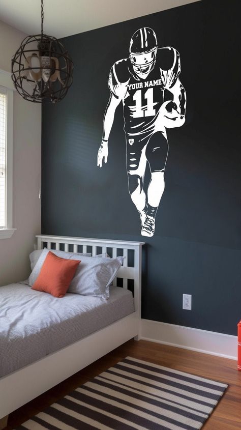 Transform your space with this Custom Football Player Wall Decal. Whether you're a die-hard football fan or simply love the sport, this wall decal offers a unique and personalized touch to your decor. Customize it with the name and numbers of your favorite player, creating a one-of-a-kind piece that truly showcases your passion. Crafted from high-quality vinyl, this durable sticker features a striking player jerseys design. It's the perfect addition to sports-themed spaces, bedrooms, game rooms, Classy Football Bedroom, 49ers Room Ideas Bedrooms, Football Game Room, Diy Football Room Decor, Nfl Bedroom Ideas, Teen Boys Sports Bedroom Ideas, Football Themed Rooms For Boys, Teenage Boys Bedroom Ideas Football, Sport Themed Bedroom For Boys