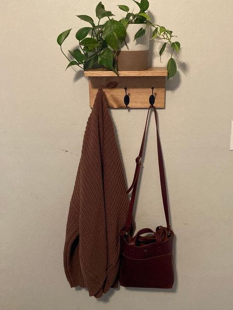 Tired of cluttered entryways and messy mudrooms? This handmade wooden coat rack organizes it all - outerwear, bags, hats, scarves and more! Custom length with sturdy hooks hold multiple coats, jackets, purses and hats. Spacious shelf neatly stores gloves, scarves, keys and other small accessories. Beautiful handcrafted solid wood design adds style to any space. With its clean lines and rich wood grain, this functional coat rack is perfect for entryways, mudrooms, dorm rooms and bedrooms. The hoo Apartment Entry Way Idea, Cute Room Storage, Hooks On Wall Bedroom, Coat Hanger Ideas Front Entry Small, Coat Rack Bedroom, Bag Hanger Ideas Bedroom, Bag Hooks Wall, Wooden Shelf Bedroom, Bathroom Decor Organization