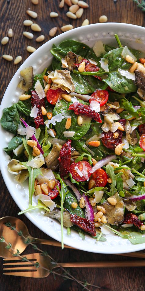 Italian Salad with Spinach, Arugula, Sun-Dried Tomatoes, Artichokes, Tomatoes, Pine Nuts, Parmesan - in a white bowl. Italian Arugula Salad, Salad Sun Dried Tomatoes, Sundried Tomato Salad, Pine Nuts Salad, Salad With Spinach, Spanish Summer, Homemade Italian Dressing, 2023 Recipes, Yummy Salads