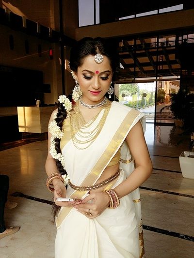 Malayalam Bride - Bride in a White and Gold Saree with Gajra in Hair | WedMeGood #wedmegood #indianbride #southindianbride #southindianwedding #saree #malayalambride White And Gold Saree, Malayali Bride, Tamil Bride, Saree White, Bride Workout, Gold Saree, Vaddanam Designs, Lehenga Jewellery, Kerala Saree