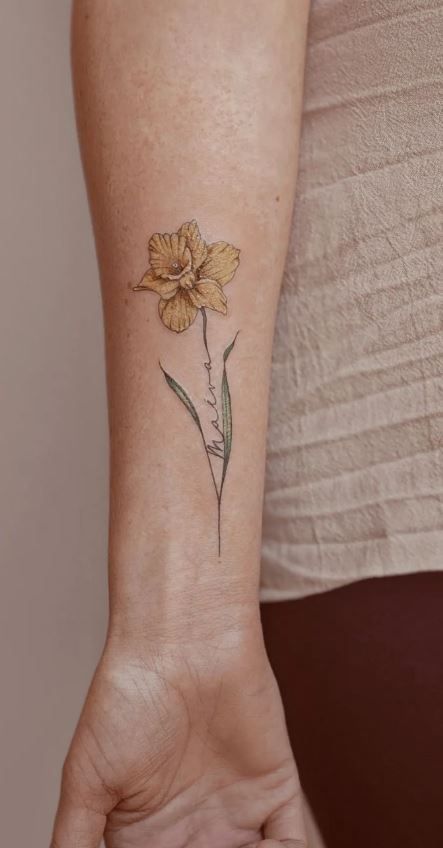 100 Meaningful Daffodil Tattoo Designs - Tattoo Me Now Daffodil With Name Tattoo, Unique Daffodil Tattoo, Daffodil Tattoo With Name In Stem, Single Daffodil Tattoo, Colored Daffodil Tattoo, Daffodil Memorial Tattoo, Daffodil Tattoo Watercolor, Rose Daffodil Tattoo, Minimalist Daffodil Tattoo