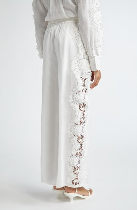 Layered lace trim meanders down the sheer sides of these relaxed tissue-linen pants cinched with a drawstring waist. 28 1/2" inseam; 27 1/2" leg opening; 14 1/2" front rise; 16" back rise (size 1) Elastic/drawstring waist Partially lined 100% linen Dry clean Imported Designer Clothing Resort Wear Couture, Fixing Clothes, White Lace Pants, Pants With Lace, Linen Wide Leg Pants, Summer 2025, Lace Pants, Lace Outfit, Linens And Lace