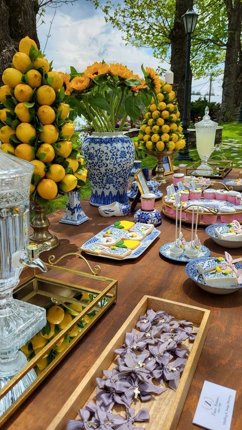 Positano Flower Arrangements, Lemon Theme Tablescape, Lemon And Blue Centerpiece Ideas, Capri Wedding Decor, Centerpieces With Lemons And Flowers, Blue White Lemon Tablescape, Mediterranean Blue Wedding Theme, Lemon And Blue Wedding Theme, Blue And White With Lemons