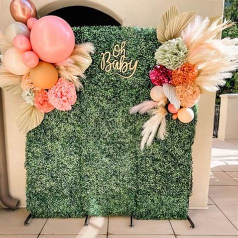 Create a stunning statement with your "Oh Baby" baby shower backdrop arrangement. Elevate your contemporary backdrop stand by draping it with a luxurious greenery wall mat. To infuse a festive flair into your backdrop, incorporate lively balloons, charming flower balls, delicate dried leaves, and elegant ostrich feathers. This combination of elements will result in the perfect birthday backdrop decoration, setting a vibrant and celebratory tone for your special occasion. Backdrop Setup, Event Decor Ideas, Party Decorations Table, Flower Balls, Greenery Wall, Shower Backdrop, Decorations Table, Baby Shower Backdrop, Flower Ball